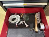 a red tool box with tools in it on the floor
