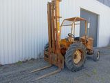 a forklift truck parked in front of a building