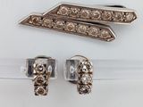 a close up of a pair of earrings on a white surface