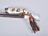 a stick with a handle that has a handle with a tassel on it