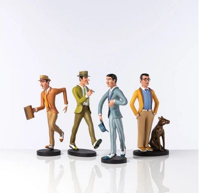 three figurines of a man and a dog on a white surface