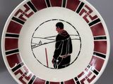 a red and black plate with a picture of a man on it