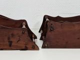 pair of antique wooden magazine racks on a white surface