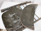 two pieces of metal sitting on top of a white table