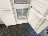 a person standing in front of a refrigerator with its door open