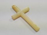 a yellow cross on a white surface with a white background