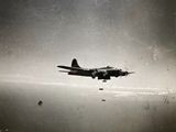 an old photo of a plane flying in the sky