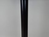 a close up of a table with a black base and a silver top