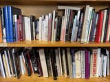 a book shelf with many books on it in a room