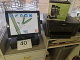 a laptop and printer sitting on a desk in front of a window
