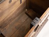 a wooden chest with a metal latch on the inside