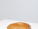 an empty wooden plate on a white table