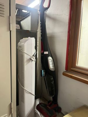 an image of a vacuum and a dryer in a small room