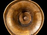 a close up of a metal bowl on a black background