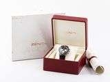 a box with a watch inside of it on a white surface