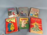 several children ' s books are lined up on a blue surface