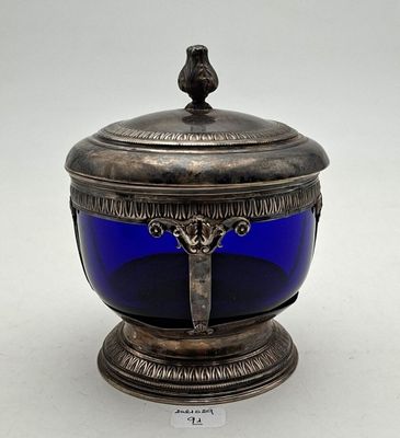 an antique silver and blue glass bowl with a bird on top