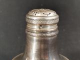 a silver bell that is sitting on top of a table