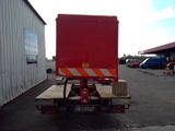 a red truck that is parked in a parking lot