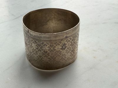 a silver cup that is sitting on a table