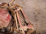 an old motorcycle that has been rusted and is sitting in a garage
