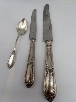 three spoons and a knife sitting on a table