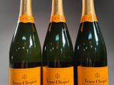 three bottles of champagne are lined up on a table
