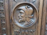 a wooden carving of a man with a hat and a beard