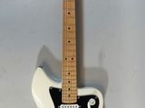 an electric guitar sitting on top of a white table
