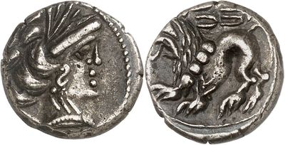 a silver coin with an image of a dragon on it