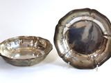 a silver plate and a silver bowl on a white surface
