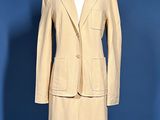 an image of a woman ' s tan suit on a mannequin stand