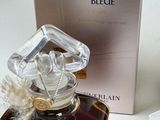 a bottle of perfume on a table next to a box