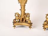 pair of antique brass candlesticks with horses and lions on them