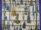 a blue and white scarf with a bunch of tassels on it