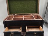 an old wooden box with two drawers inside of it