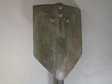 a metal spatula with holes in it on a white surface