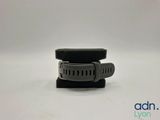 a close up of a watch on a stand on a white surface