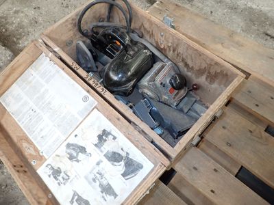 a box with a small engine in it on a pallet