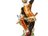 an image of a figurine of a man sitting on top of a rock