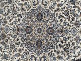 a close up of a rug with a blue and white design on it