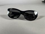 black sunglasses on a white surface with a pair of black glasses