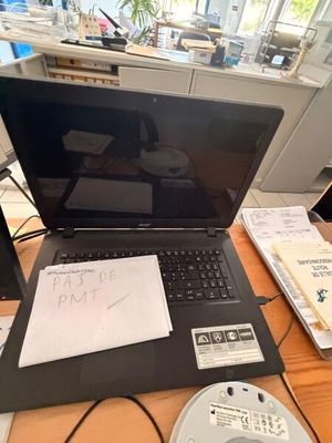 a laptop computer sitting on top of a wooden desk
