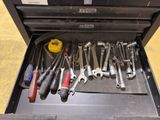 many tools in a tool box on the floor
