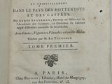 an old book with writing on it sitting on top of a table