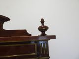 a clock sitting on top of a dresser in a room