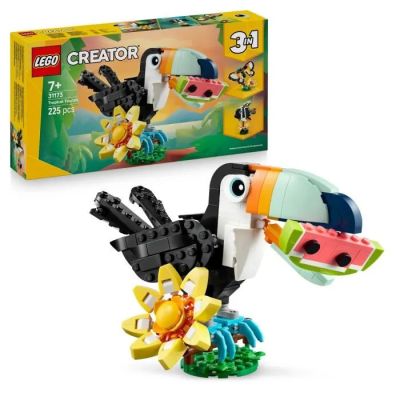un oiseau Lego Creator tenant une fleur devant une boîte