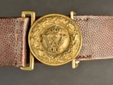 a close up of a belt with a gold buckle on it