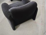 a black recliner sitting on the floor in a room