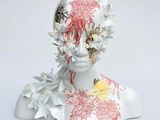 a sculpture of a woman with flowers on her head
